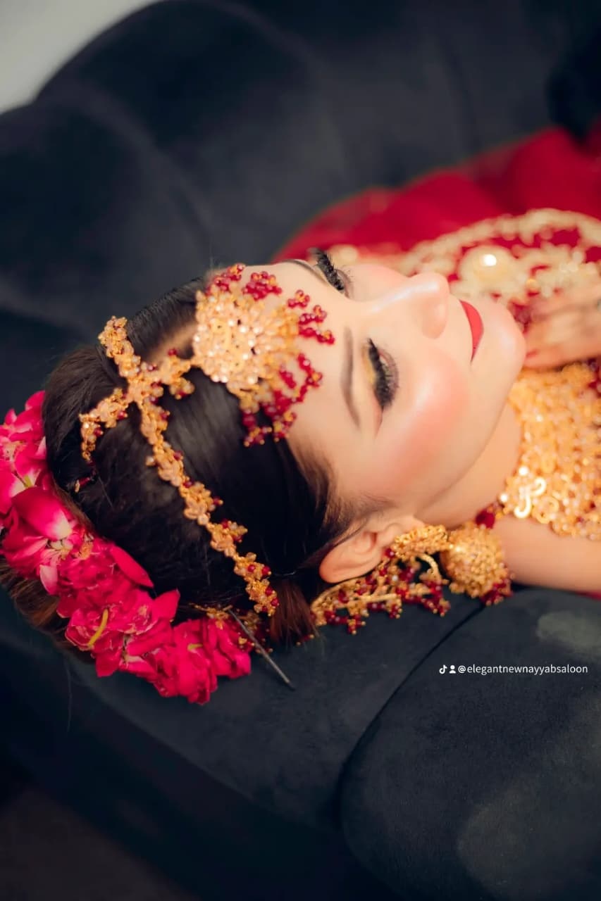Bridal makeup with deep red outfit and emerald jewellery